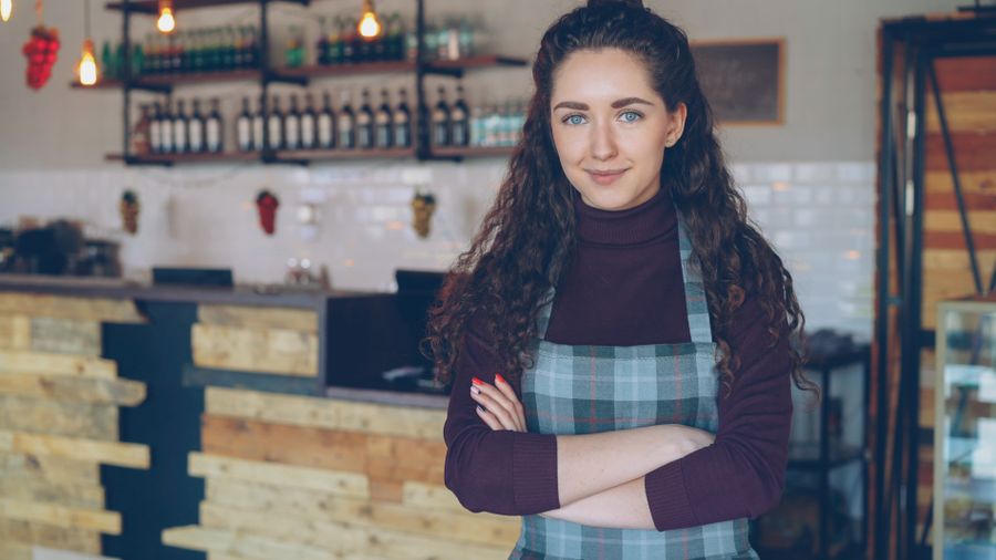 Small business owner running her shop while her website is fully managed in the background