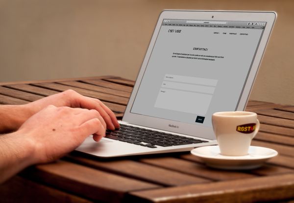 Hands typing on a laptop next to coffee, representing practical tips